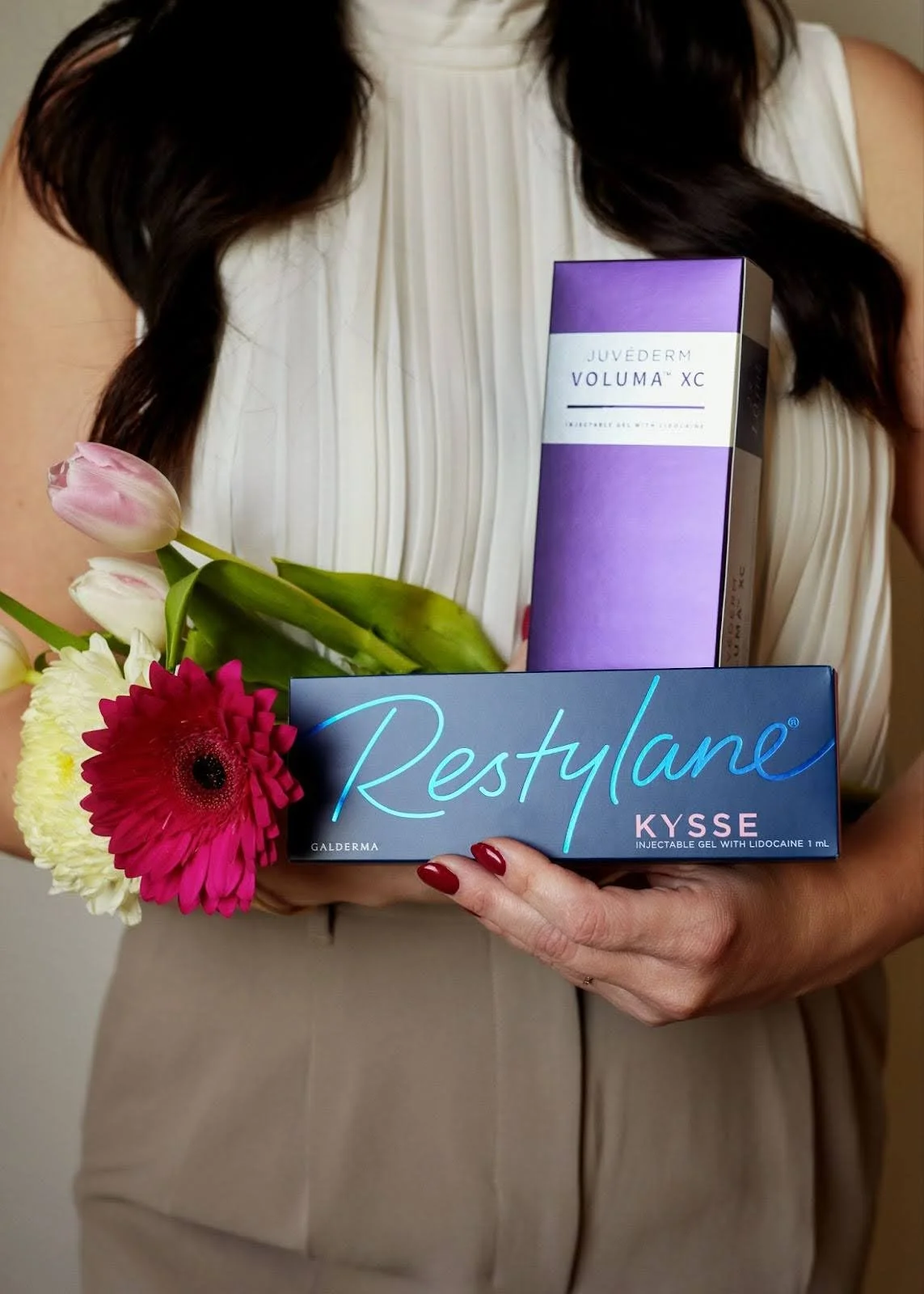 Injx Bar provider holding Juvederm dermal filler products used for lip and facial filler treatments near Peoria, AZ.