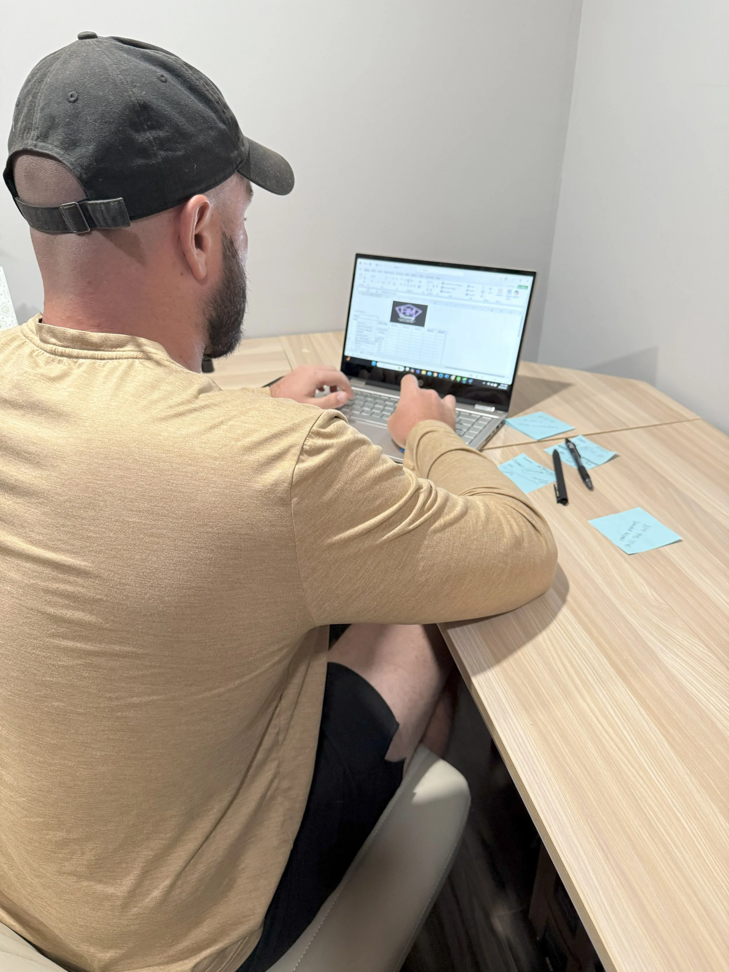 Rusty Miller designing personalized online training programs for remote coaching clients.