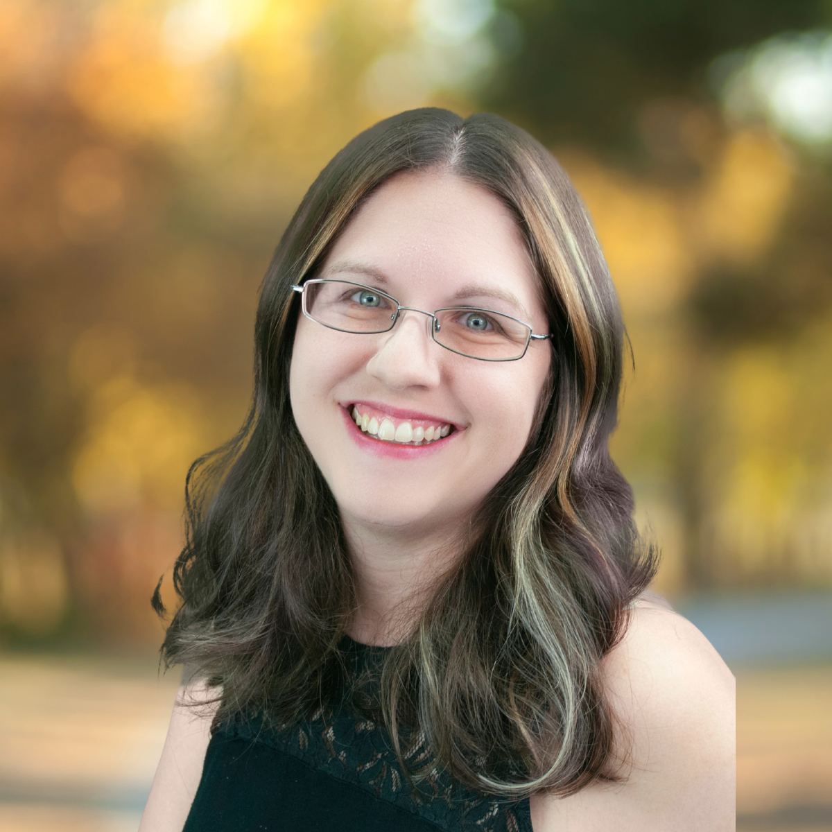 Smiling woman with glasses and long brown hair, wearing a black top, against a brown textured background.
