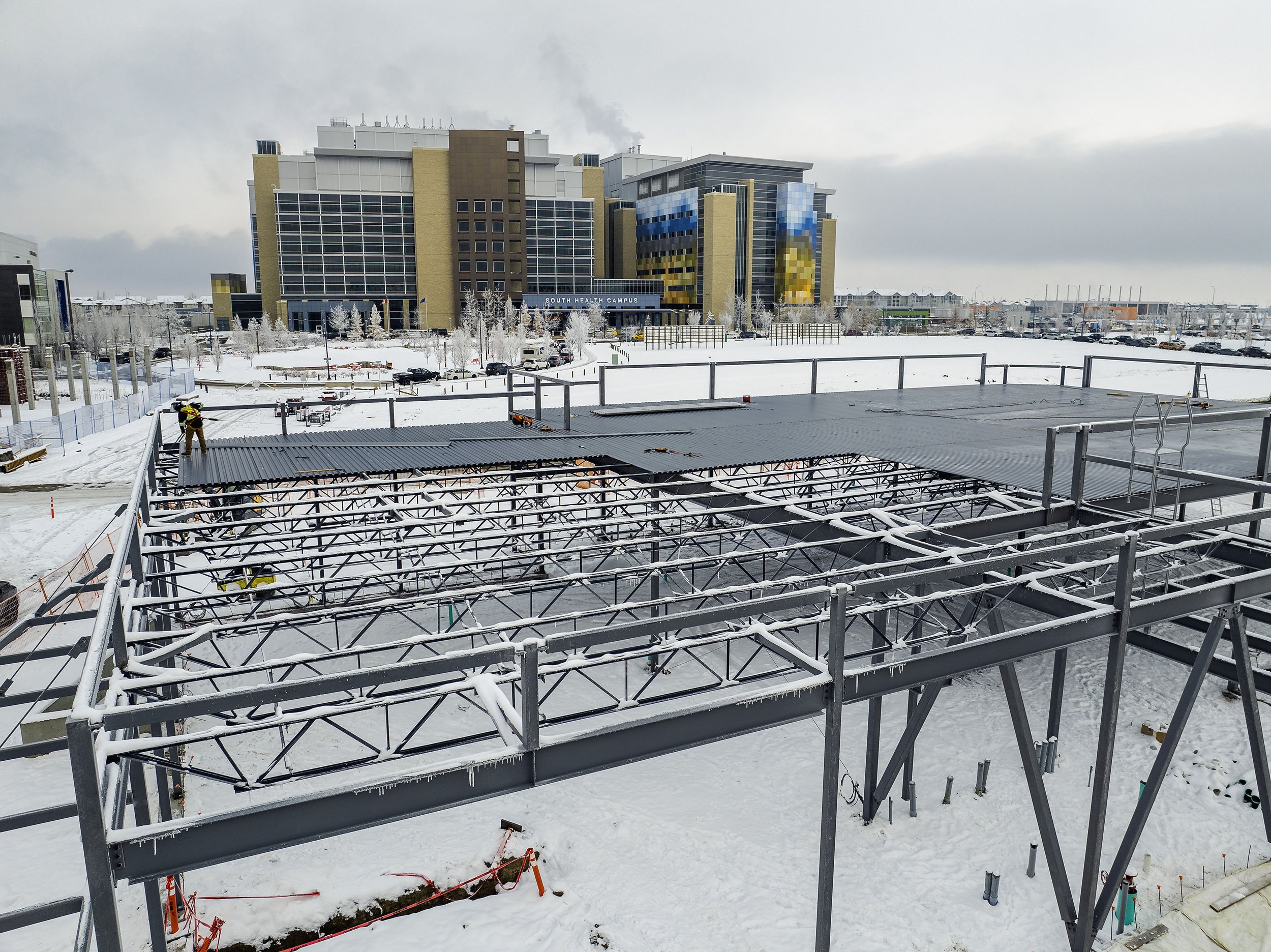  Framers working on a winter day on a  building in front of AHS South Health Campus  