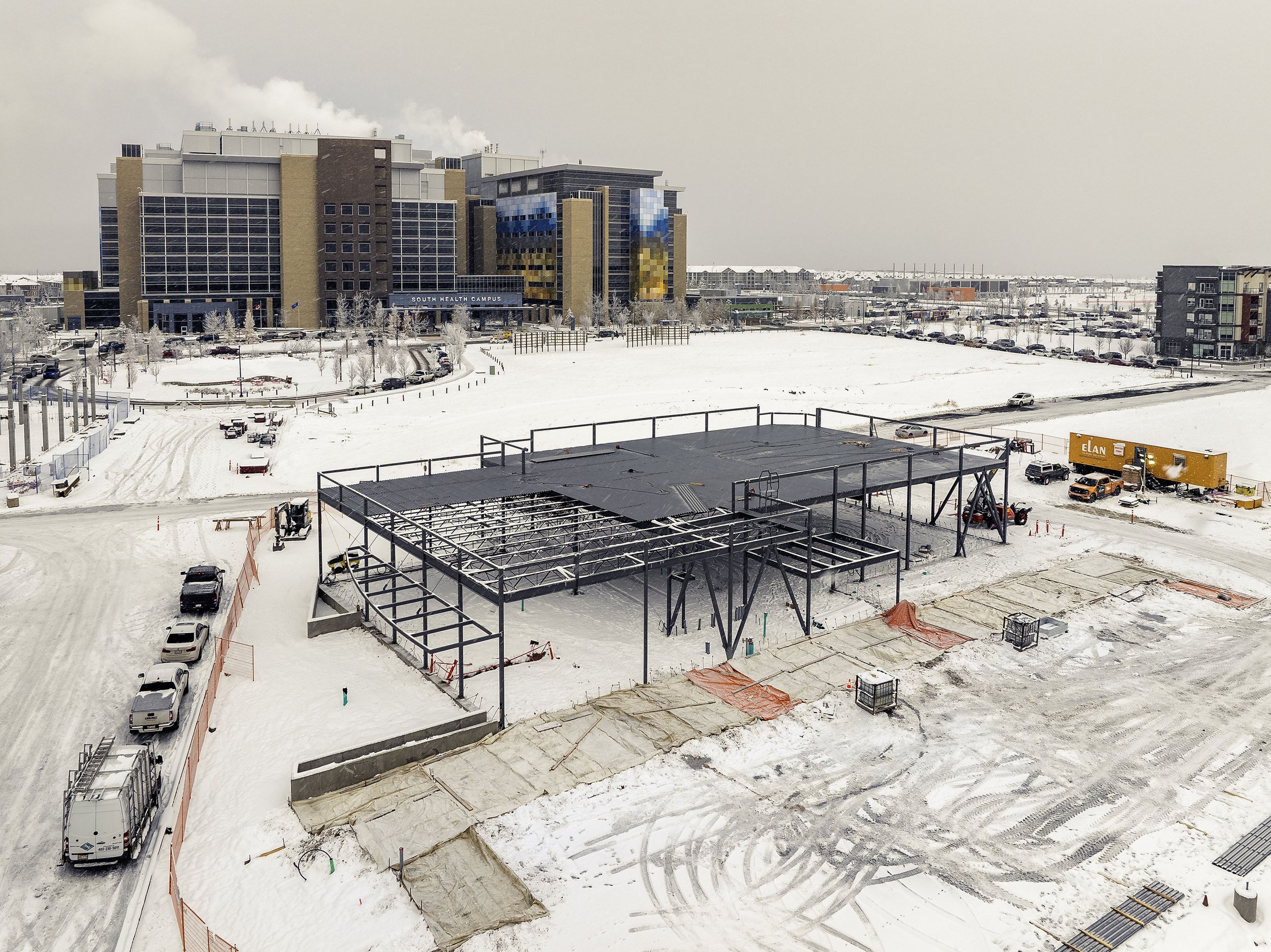  Framers working on a winter day on a  building in front of AHS South Health Campus  
