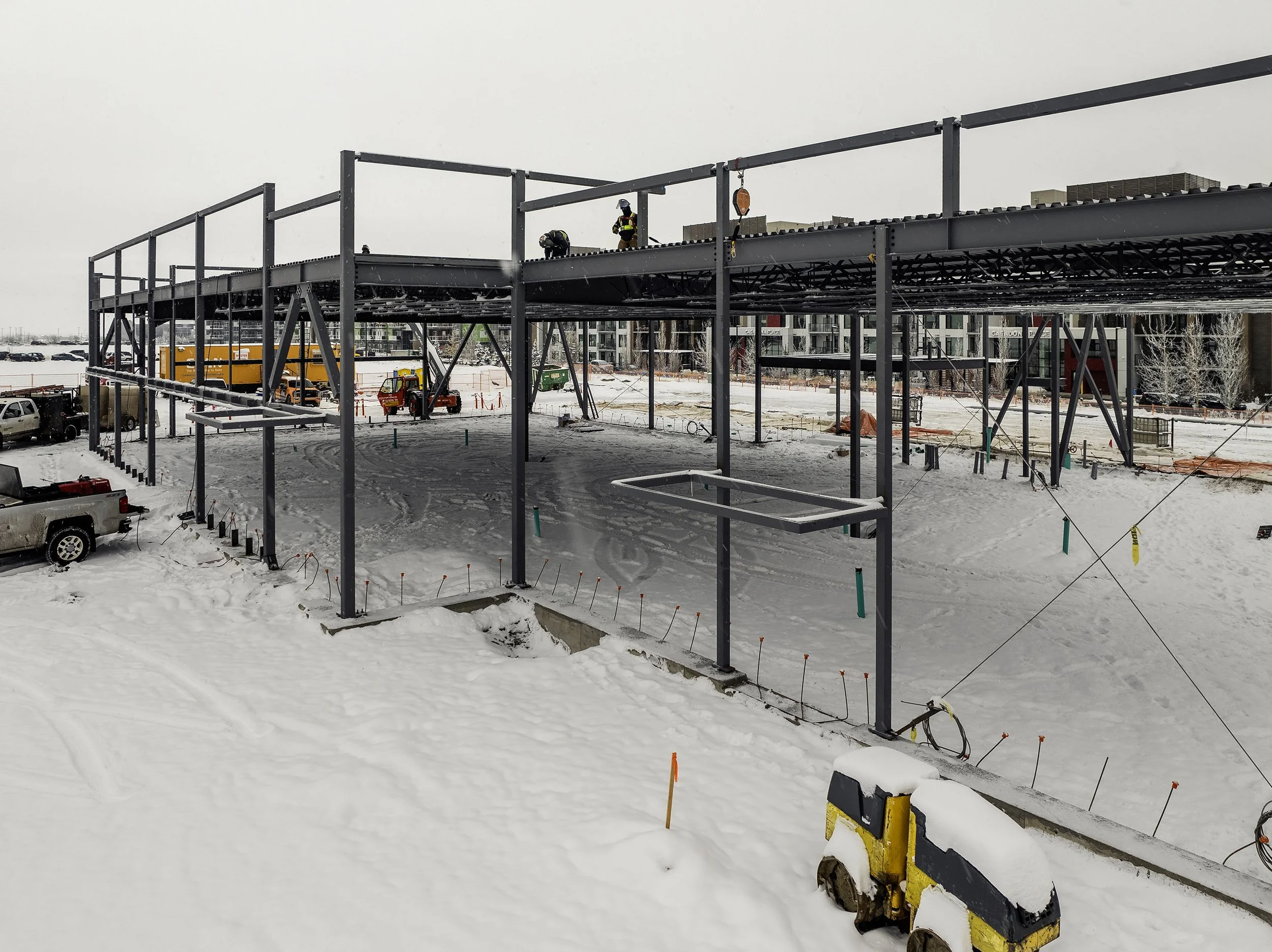  Framers working on a winter day on a  building in front of AHS South Health Campus  