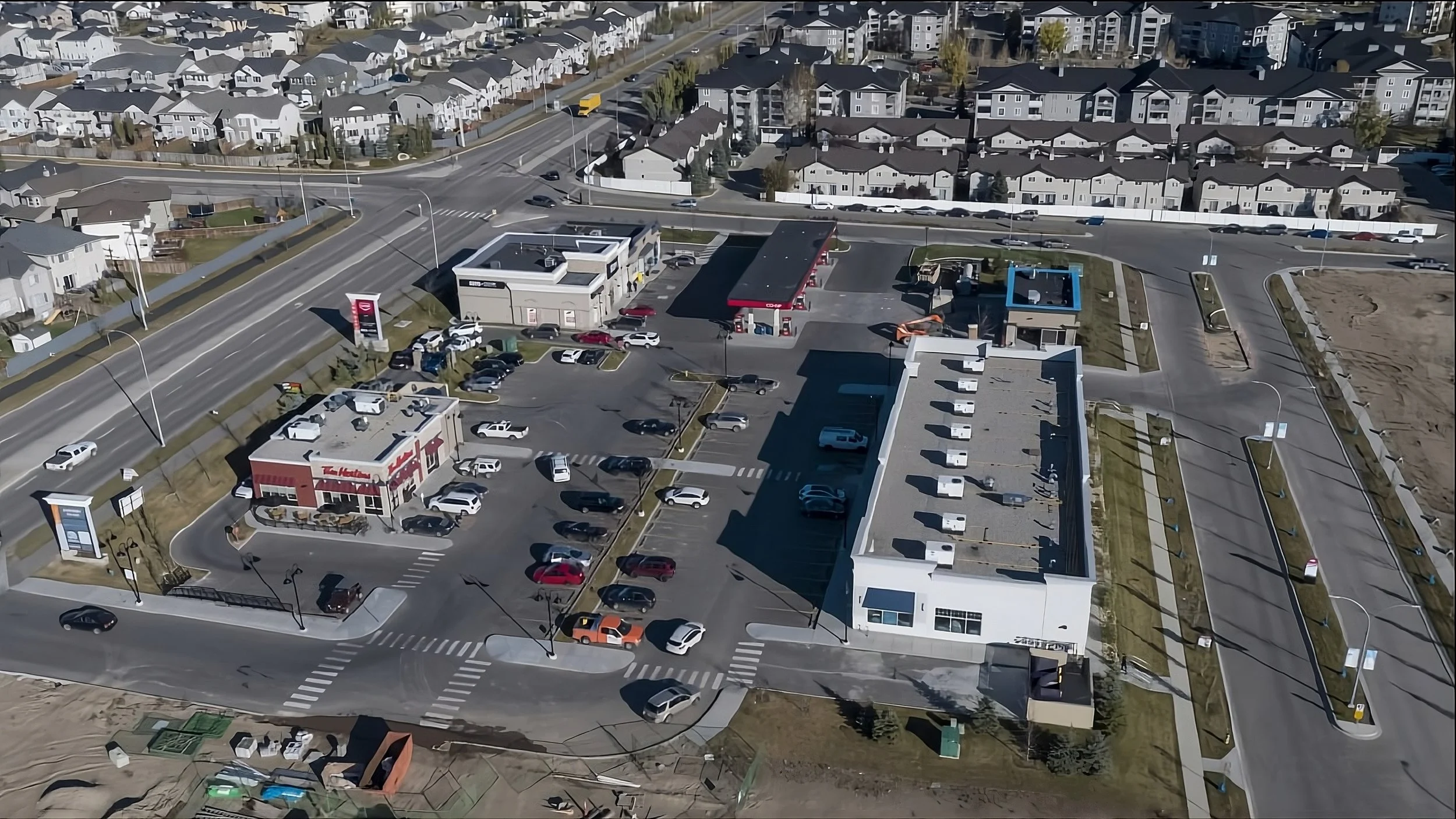 A top-view of a small shopping plaza with a tim hortons and co-op gas bar in view