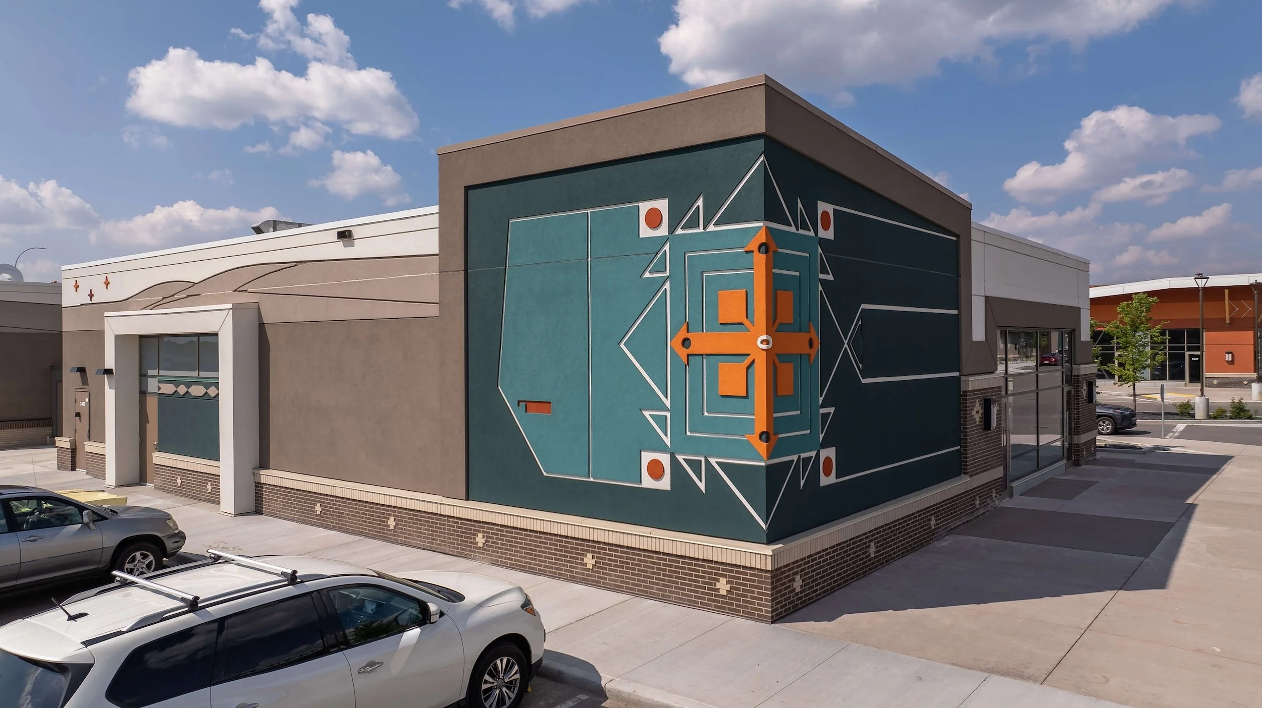 taza-shops-at-buffalo-run-orange-and-green-native-motif-art-building-elan-construction.jpg