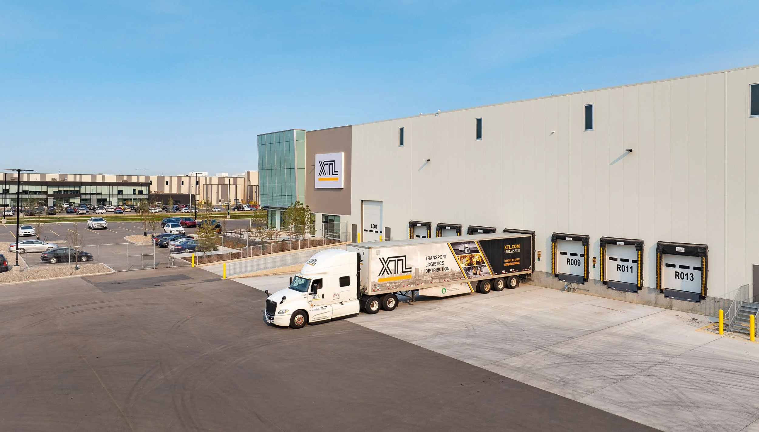 XTL building side view with semi-truck