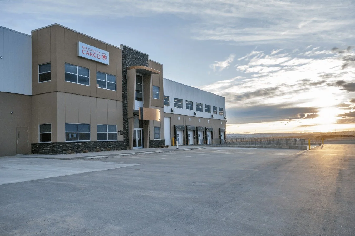 The brown and grey air canada cargo building with the red logo on it
