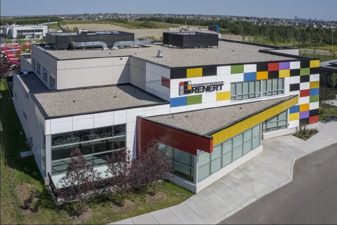 A white building with a bold primary colours in a checker mark pattern