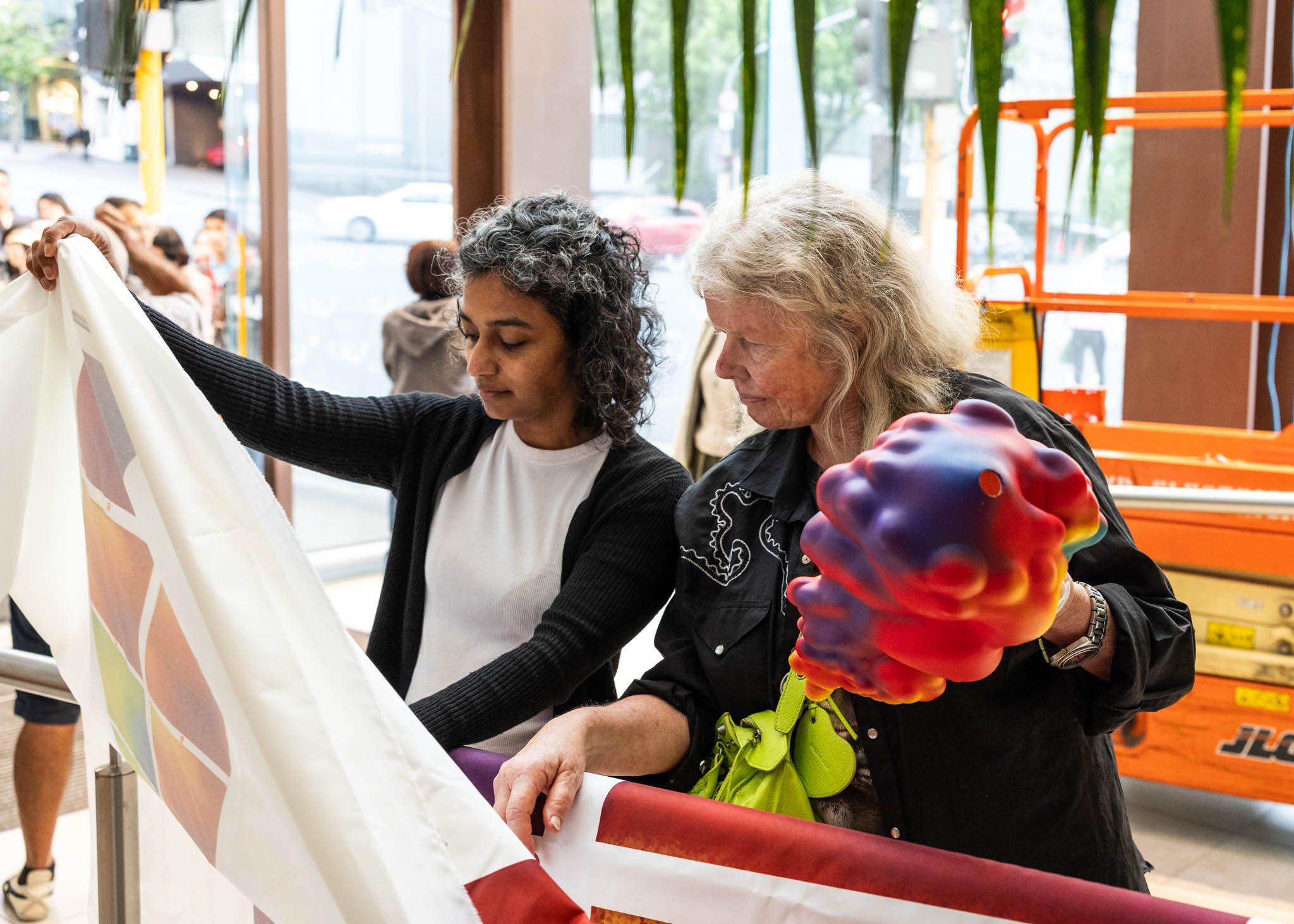 Testing sample and scale model of Ether a new public artwork are artist Judy Darragh and Kanika Jhunjhnuwala in the atrium of Sudima Auckland City Hotel.