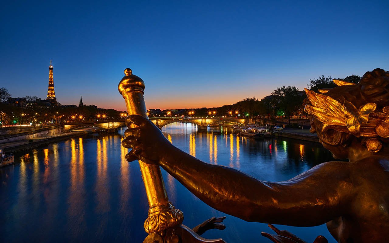 Ian Borthwick, Untroubled Waters 1 , 2020
The mighty Seine, as tranquil as a mill pond, as seen from the city’s most ornate bridge, the Pont Alexandre III. Normally, on a warm spring evening such as this the quays along the Seine are thronging wi