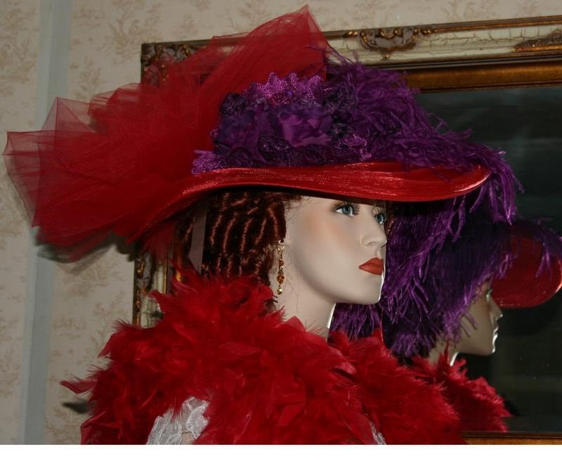Sideview of Red Victorian Tea Party Hat accented with purple lace and purple roses.