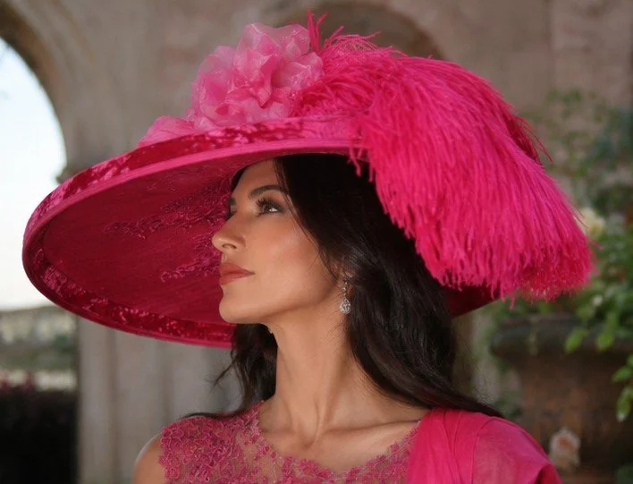 Hat Embellishments: A striking hot pink rose, accompanied by glorious fuchsia ostrich feathers, adds a touch of extravagance.