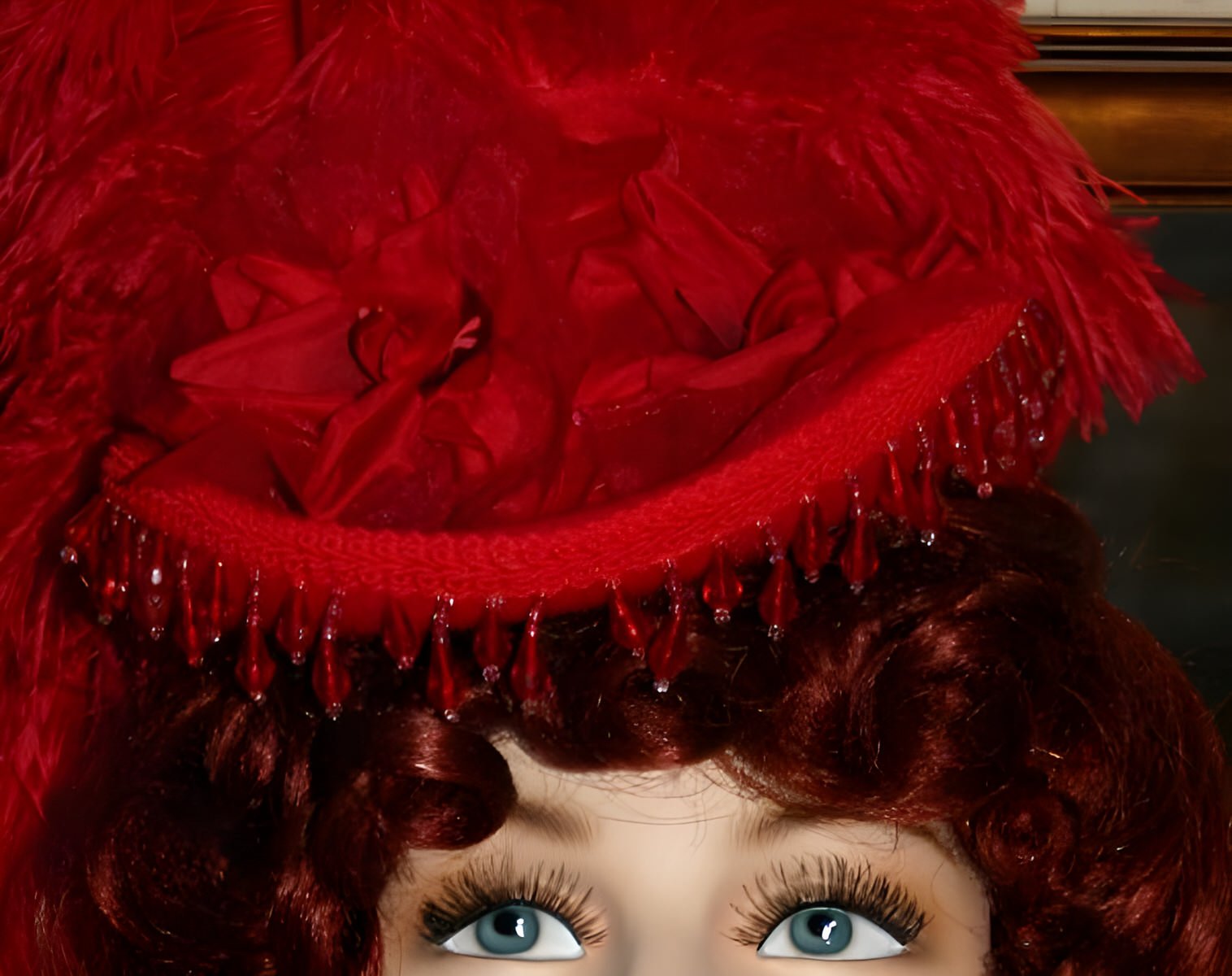 Timeless elegance with a small-brim, all-red Victorian-style hat adorned with ostrich feathers, French beaded trim, and silk bow.