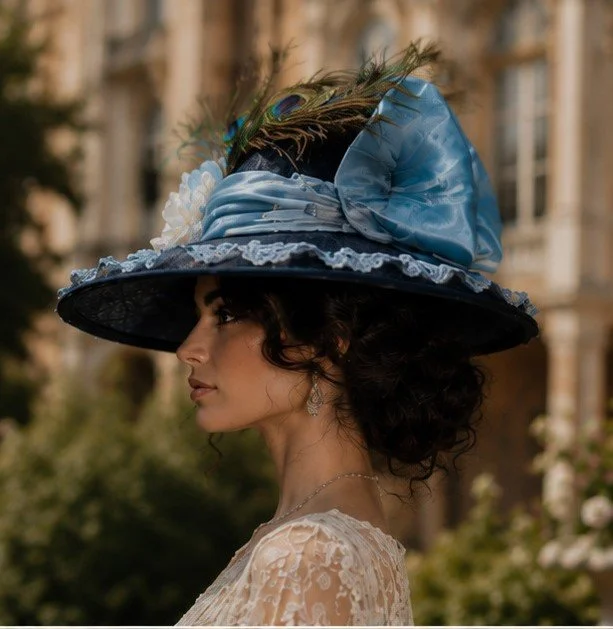 Side view of lovely woman wearing an Edwardian Hat for women adorned with silk taffeta and blue appliques.