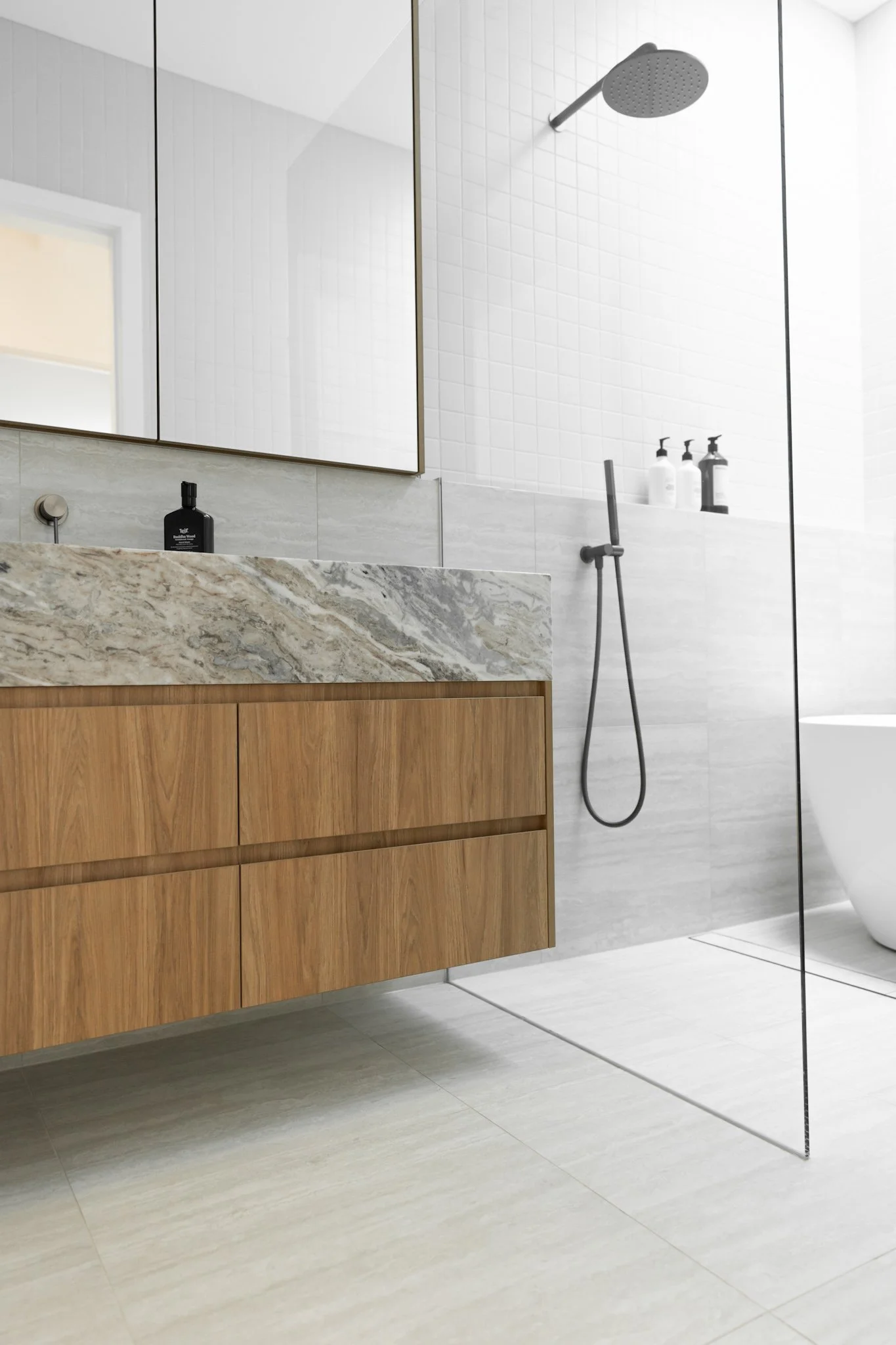 Williamstown Residence bathroom with natural stone vanity and custom timber joinery by Build One and ARKO Joinery
