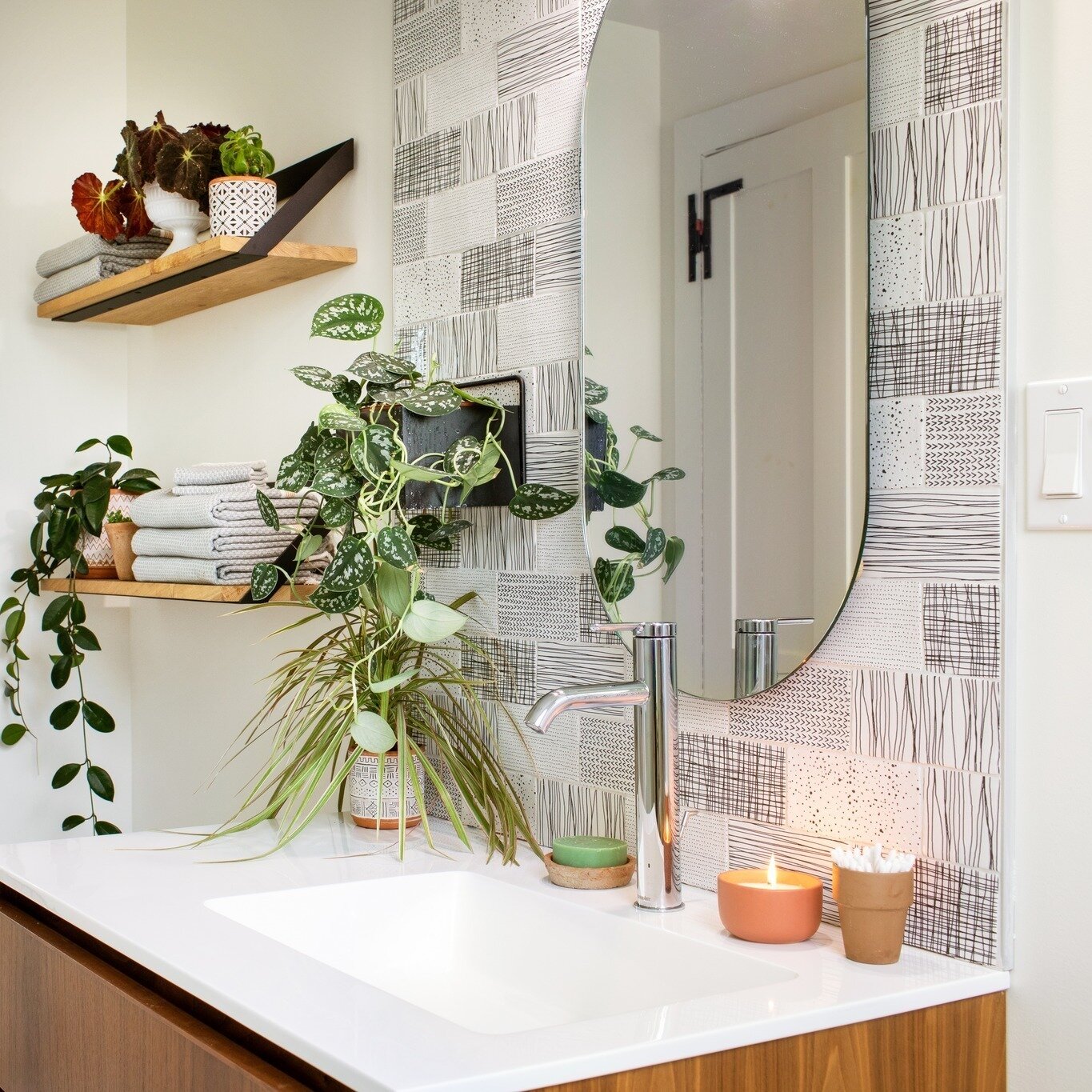 This warm winter day on Maryland's Eastern Shore is inspiring thoughts of spring and thanks to a large skylight this fun bathroom is, too. Fresh, sunny and plant happy all year long we loved creating this mix of warm woods, modern touches and graphic
