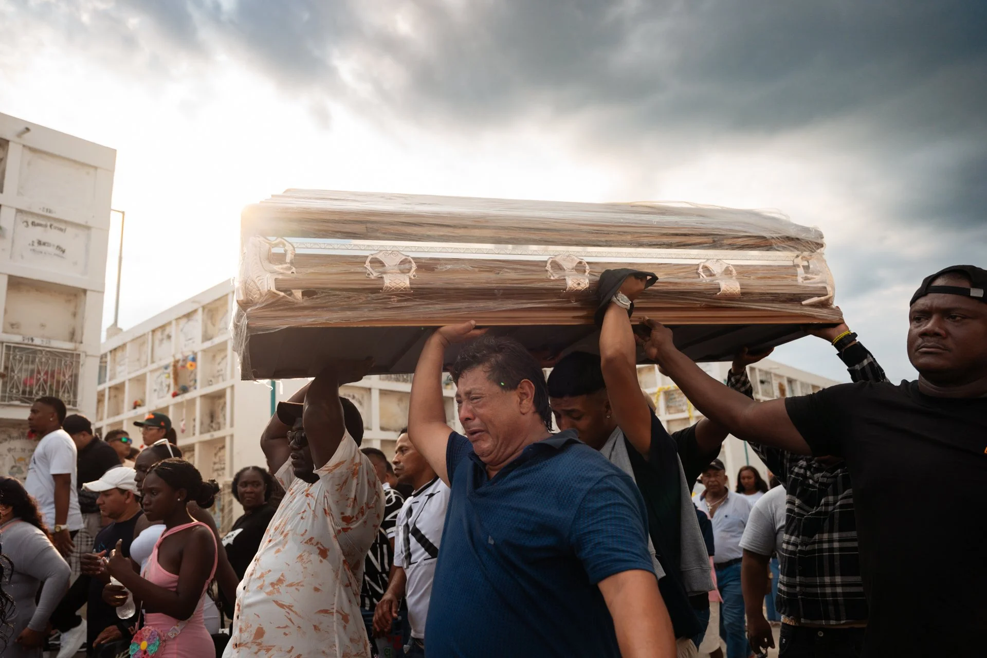 Residents of the Las Malvinas neighborhood carry the coffins of four boys who disappeared on December 8 after being detained by military personnel. Their burned bodies were later found in Taura, near a military base. The case has sparked nationwide o