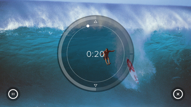 A person surfing big ocean waves with a timer overlay showing 20 seconds.
