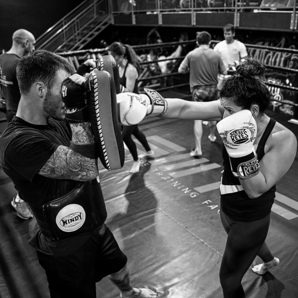 Technical Muay Thai pad work at 8Tribe San Diego—small-group training session.