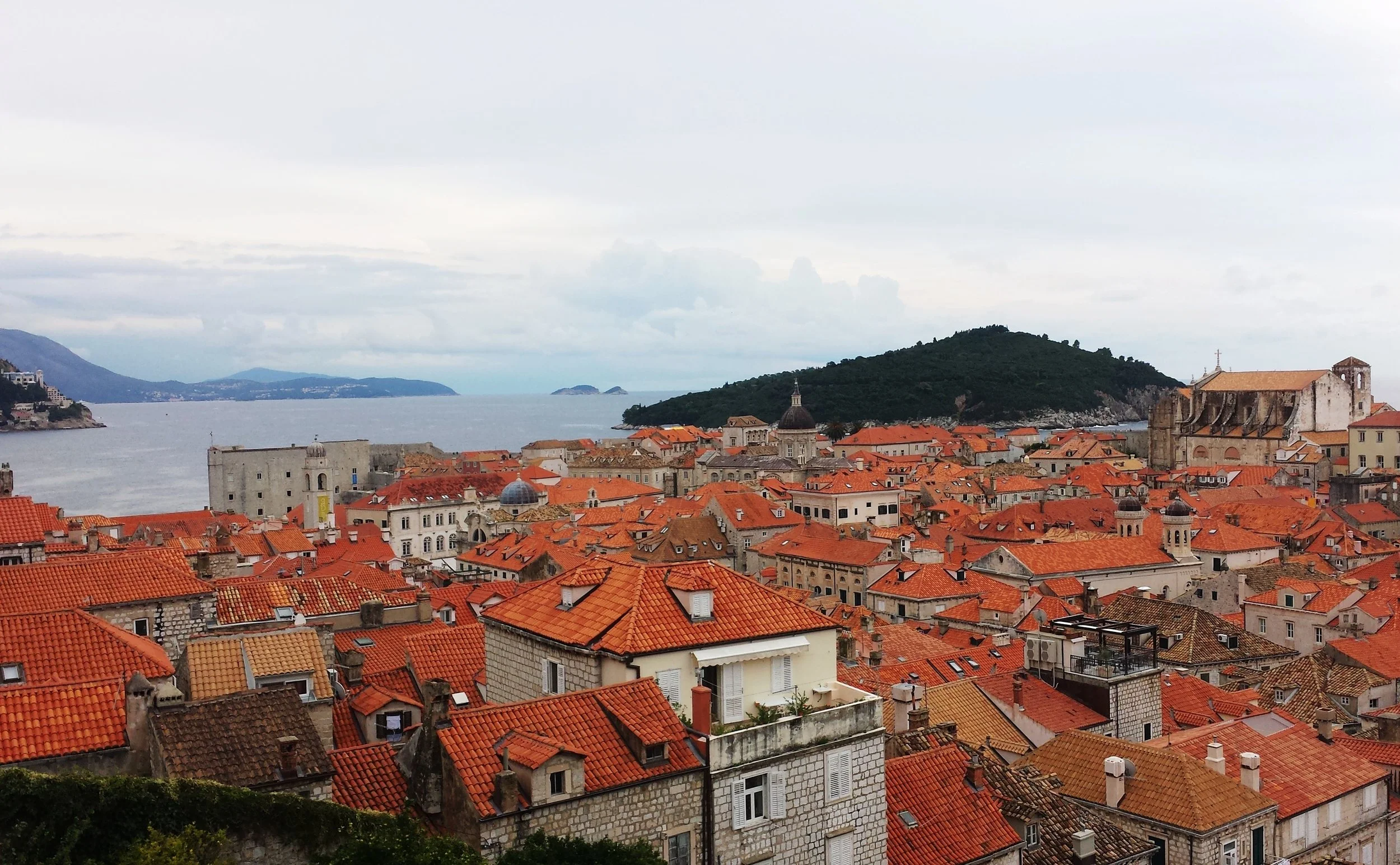 Overview of Dubrovnik, Croatia with the sea in the background. Orange roofs everywhere.