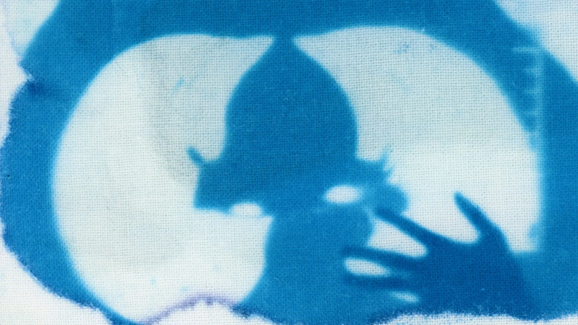 Blue stencil silhouette of a person making a peace sign with their hand, with a circular background that appears to be a swimming pool.