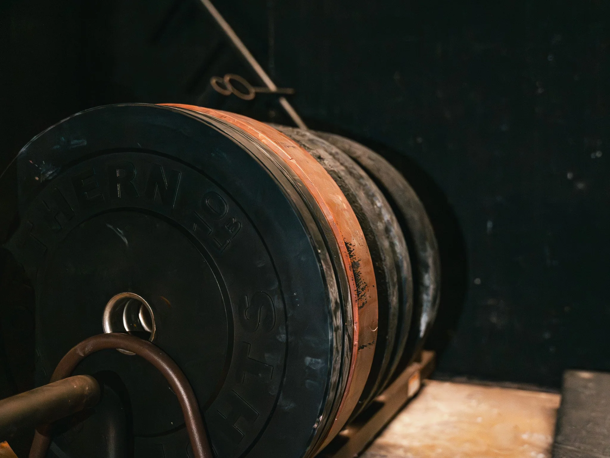 Heavy weight plates loaded on strength-training equipment