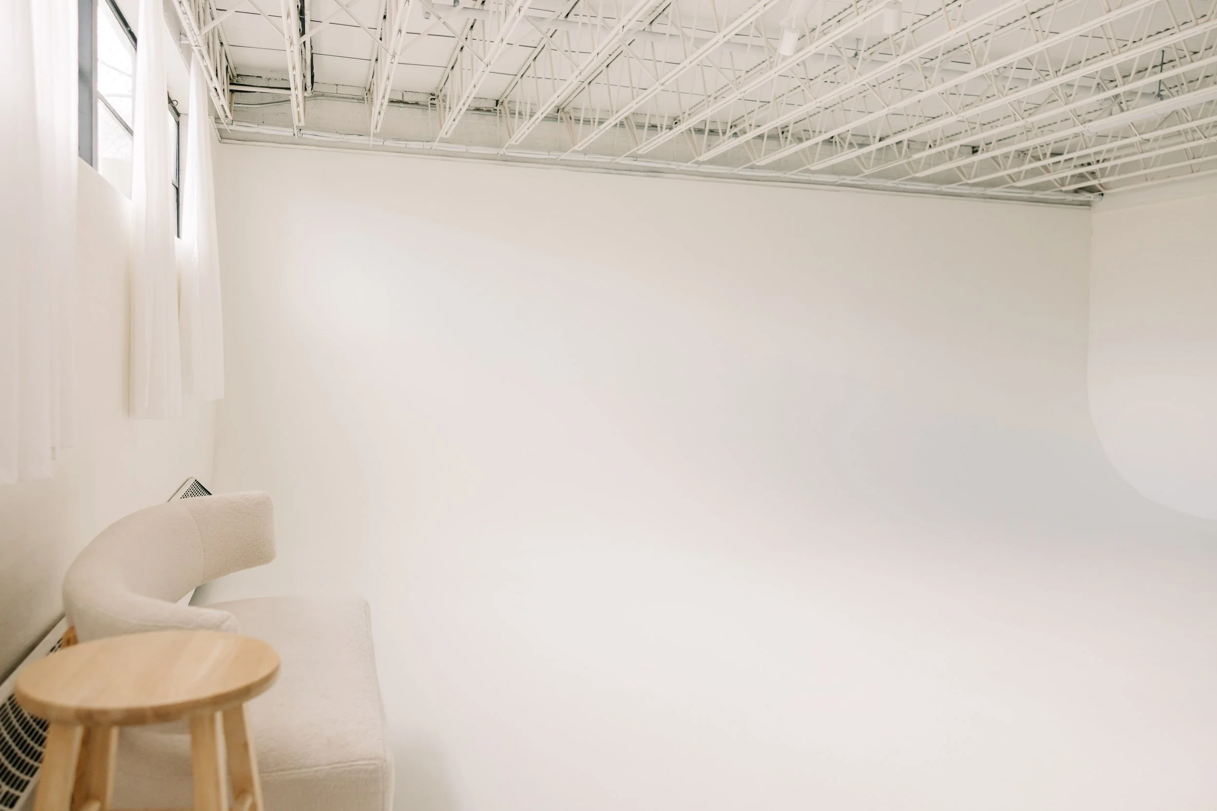 Image of cyclorama wall at Northern Colorado photography studio with south facing windows and furniture
