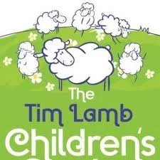 Illustration of cartoon sheep on a green hill with daisies, featuring the text "The Tim Lamb Children's Center."
