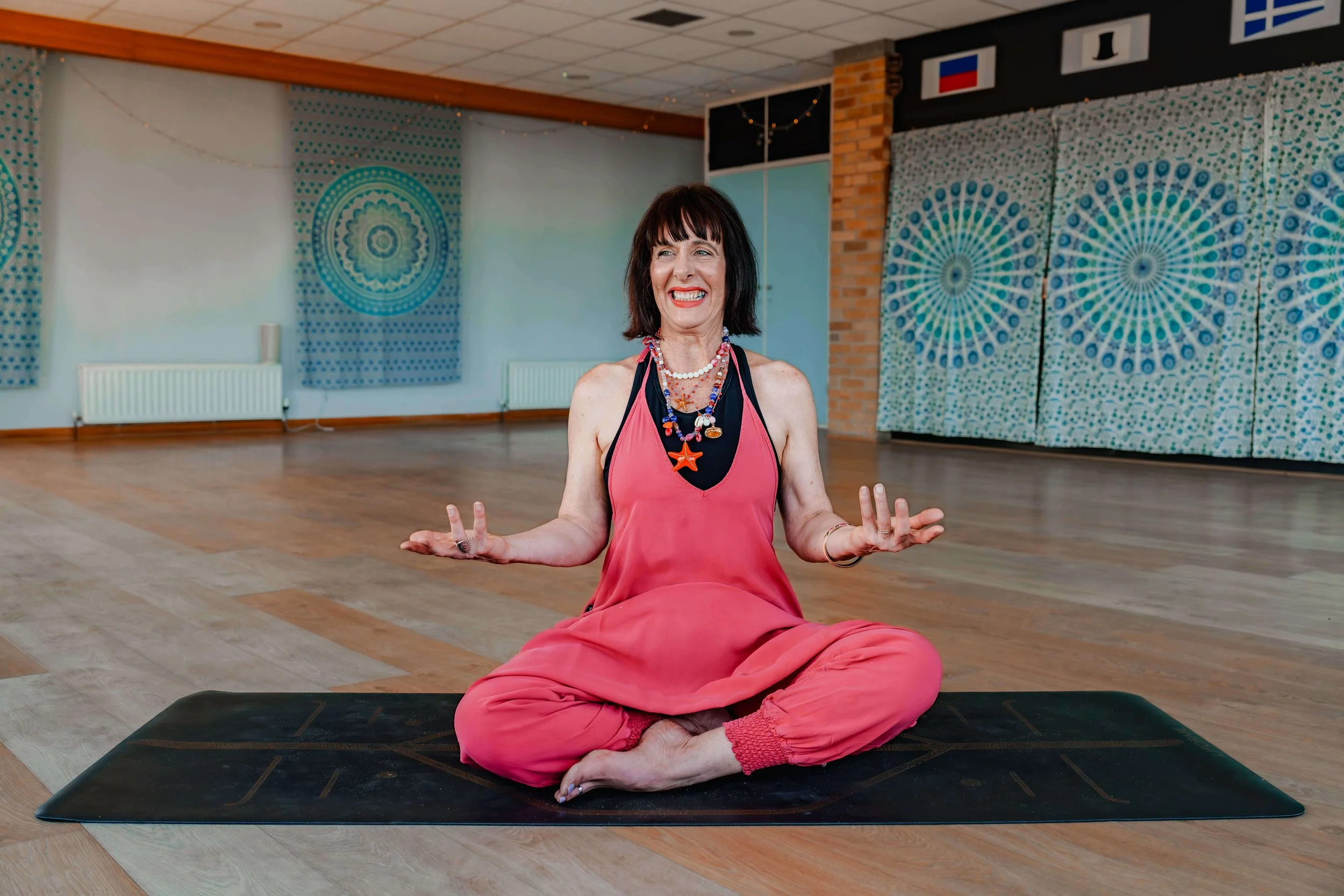 Steph at Jasmine Yoga arranges the props for a beginner class