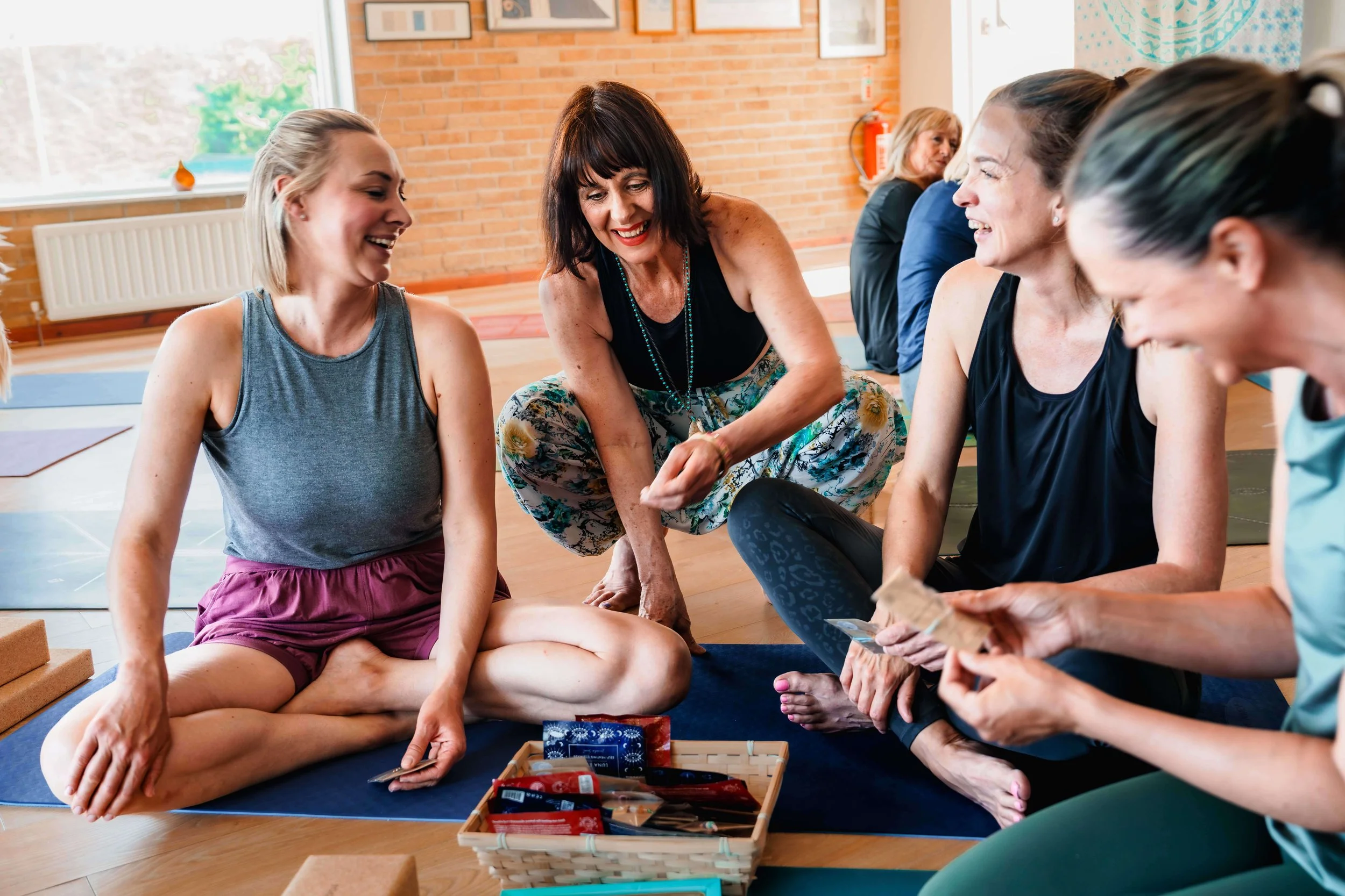 Jo at Jasmine Yoga supports a student with their yoga practice at an event