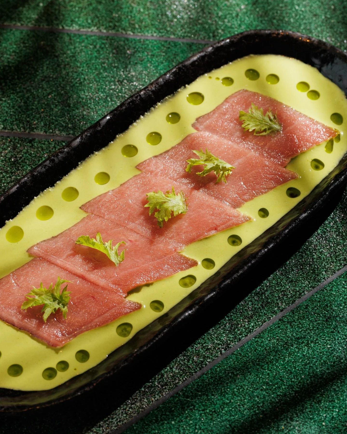 Chūtoro Tiradito.

Medium fatty bluefin tuna, jalape&ntilde;o sauce, wasabi leaf.

One more plate? Always.