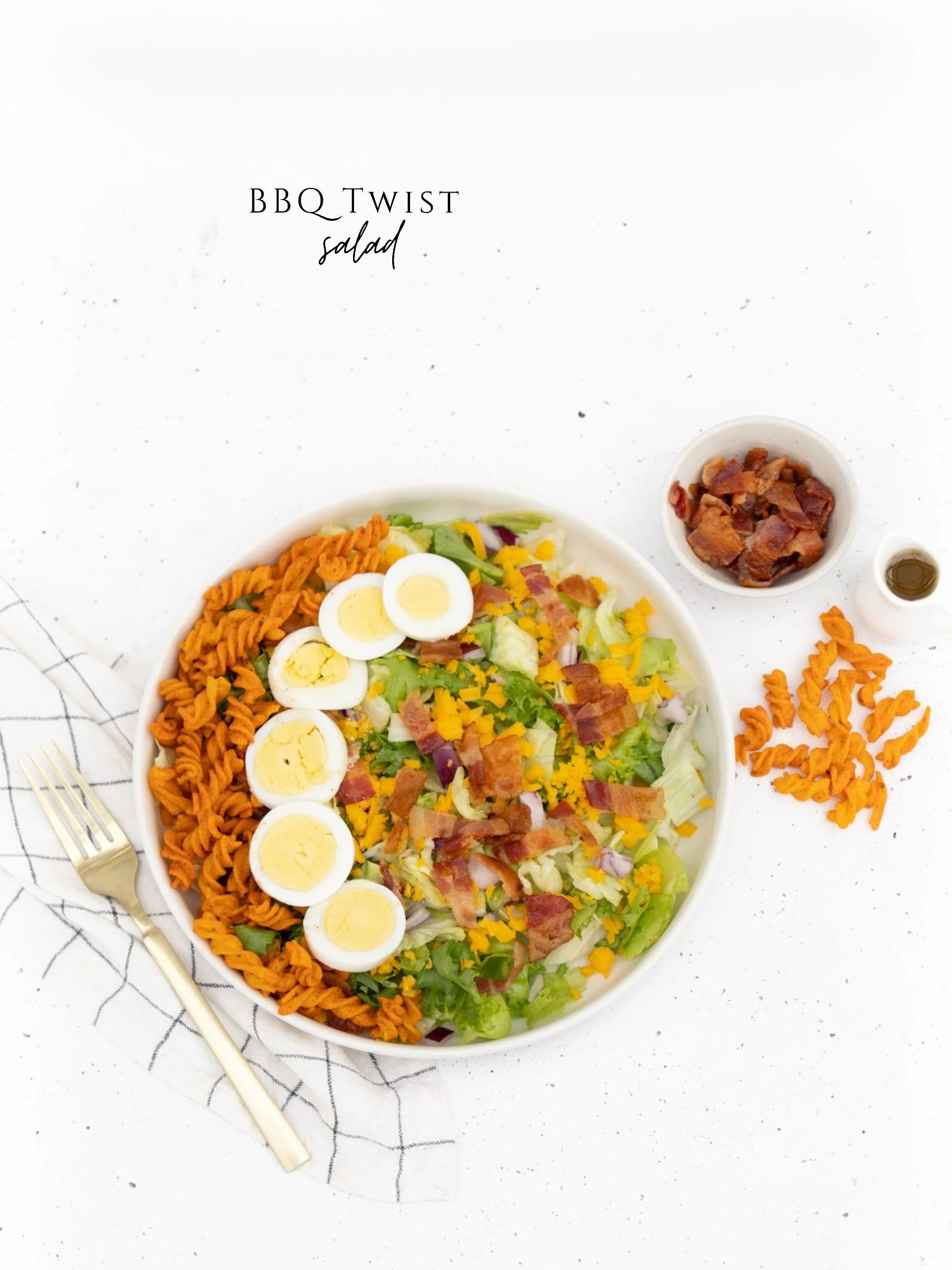 Fresh, crisp greens piled with shredded cheddar cheese, sliced hard-boiled eggs, purple onions, smoky bacon crumbles, and crunchy BBQ twists for the perfect extra crunch. Served with a side of house made dressing.