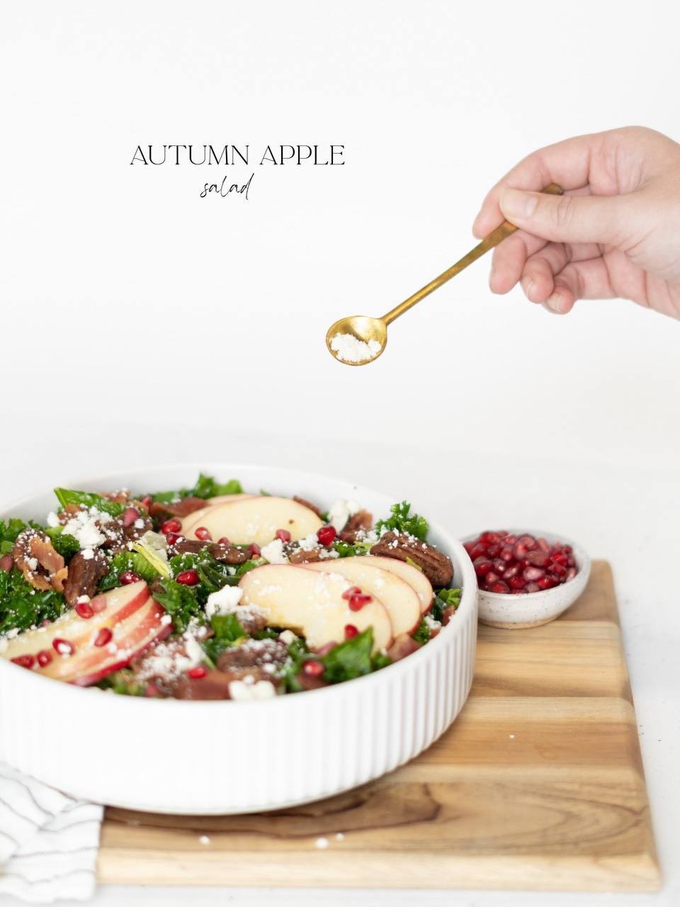 Fall salad season has officially arrived. 🍎🍂 Crisp leafy greens and kale are topped with juicy Honeycrisp apples, tart pomegranate arils, creamy feta, and crispy bacon&mdash;basically everything you could want in a fall salad. Drizzled with our swe