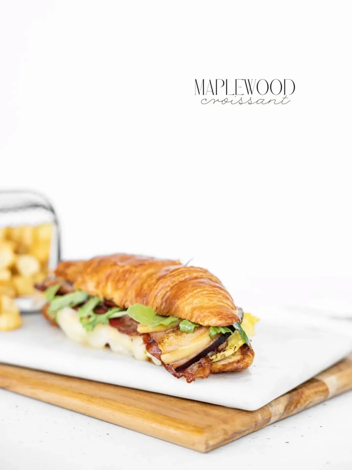 Fried egg, topped with mozzarella cheese, smoked bacon, ham, fresh arugula, and layered with grilled apple slices and our housemade creamy maple dressing, served piping hot in a soft croissant roll. Let this breakfast sandwich steal the show of your 
