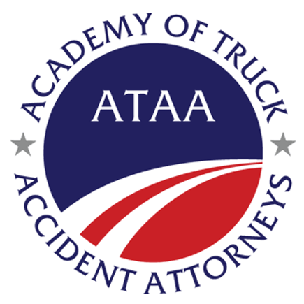 A Circular logo which says "Academy of Truck Accident Attorneys" in bold red, white, and blue with white swoops dividing the red from the blue sections of the circle