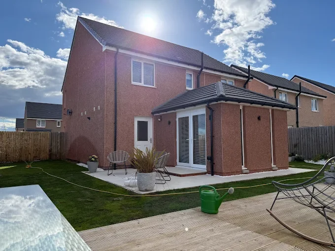 red brick extension with double doors and tiled roof