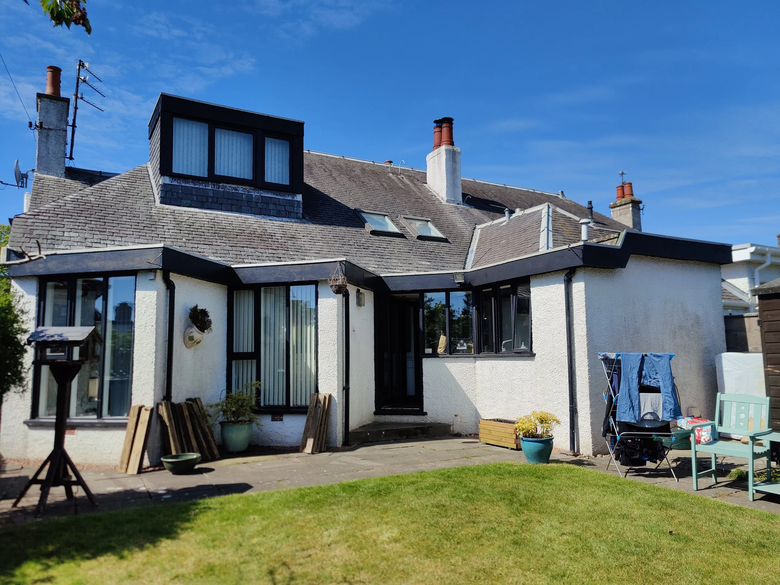 house with white render and slate roof