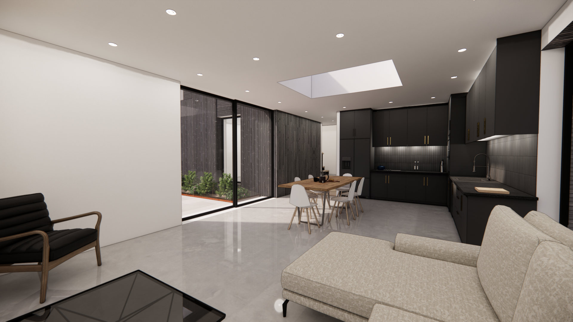 interior view of kitchen, with black kitchen on right, table in centre middle ground and seating area. large sliding door windows and rooflight
