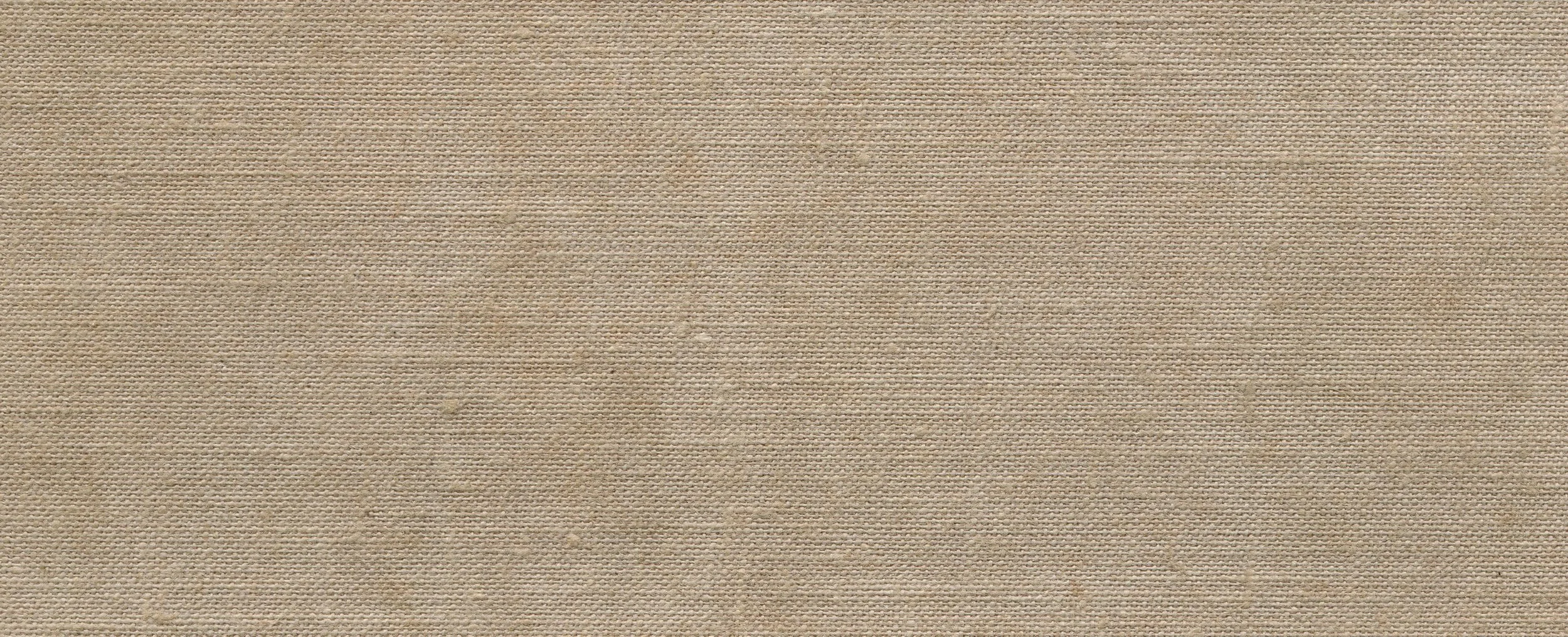 A close-up view of beige textured fabric with small, evenly spaced dots.