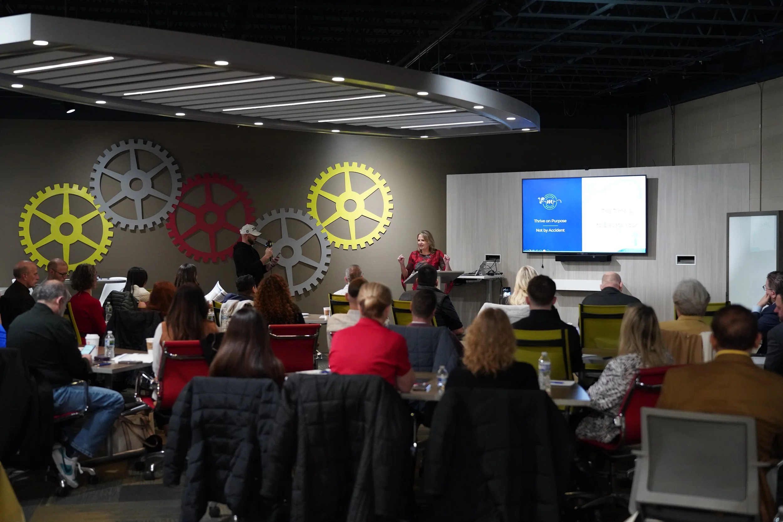 Conference room with people sitting listening to a presenter