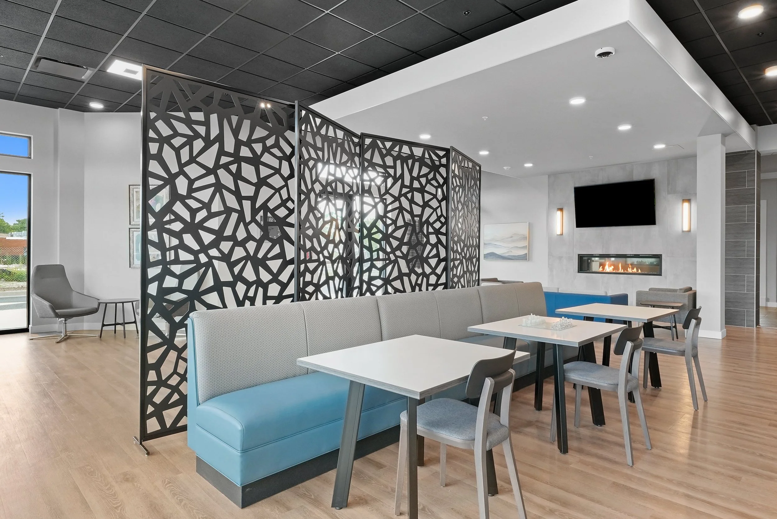 Employee break room with blue bench seat and wall divider