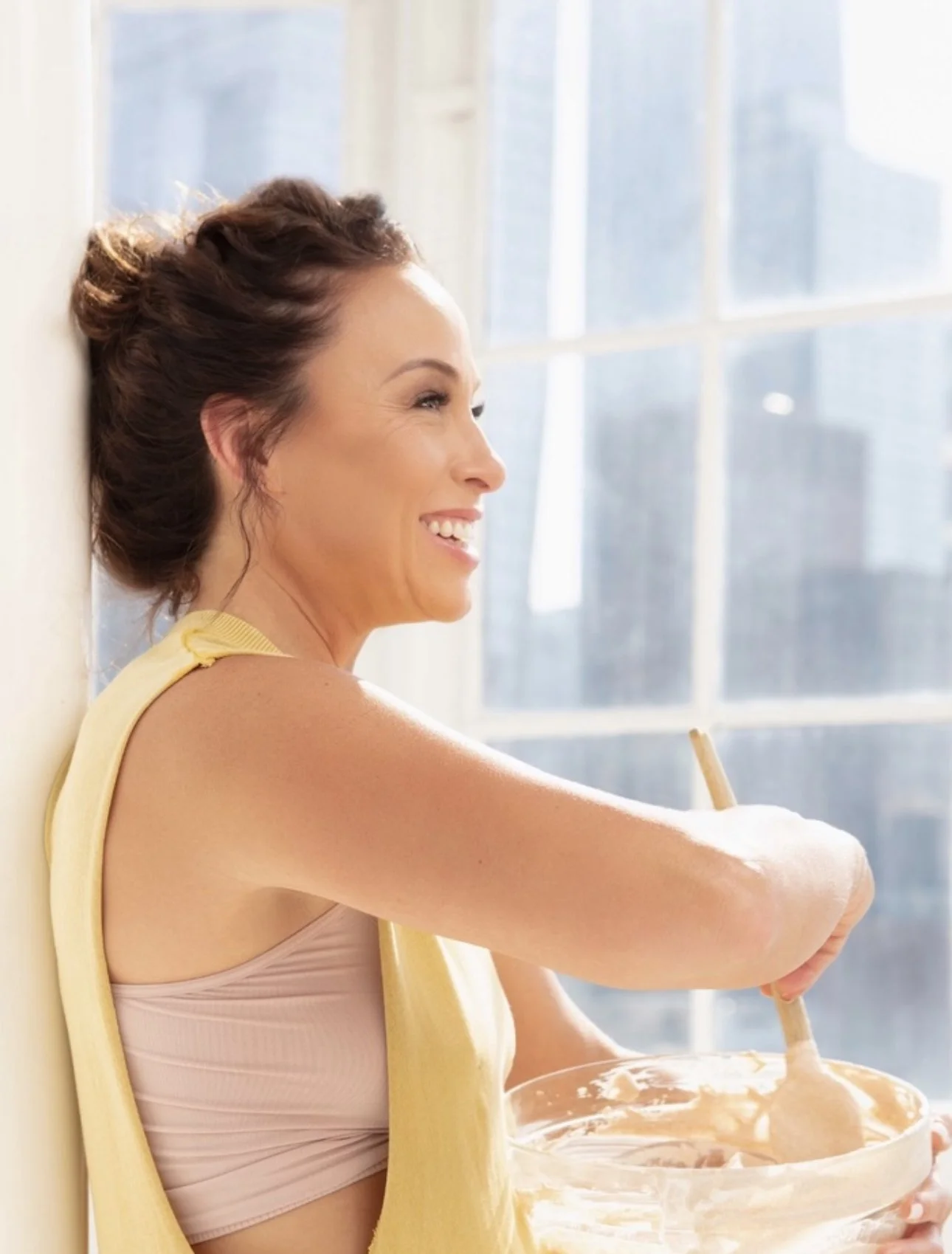 Christina stirring a fresh batch by the window