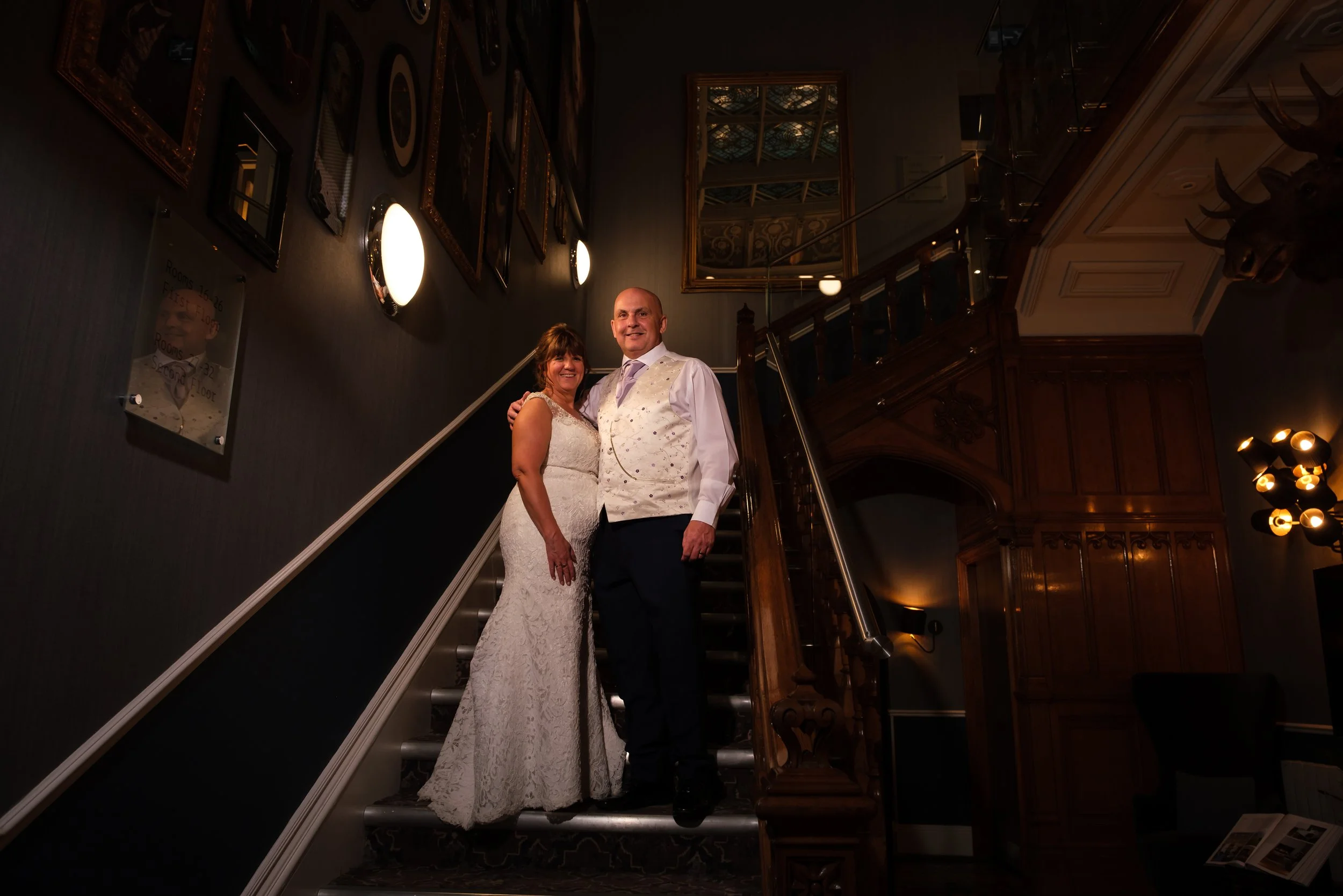Bride & Groom stand on the staircase at Oddfellows on the Park