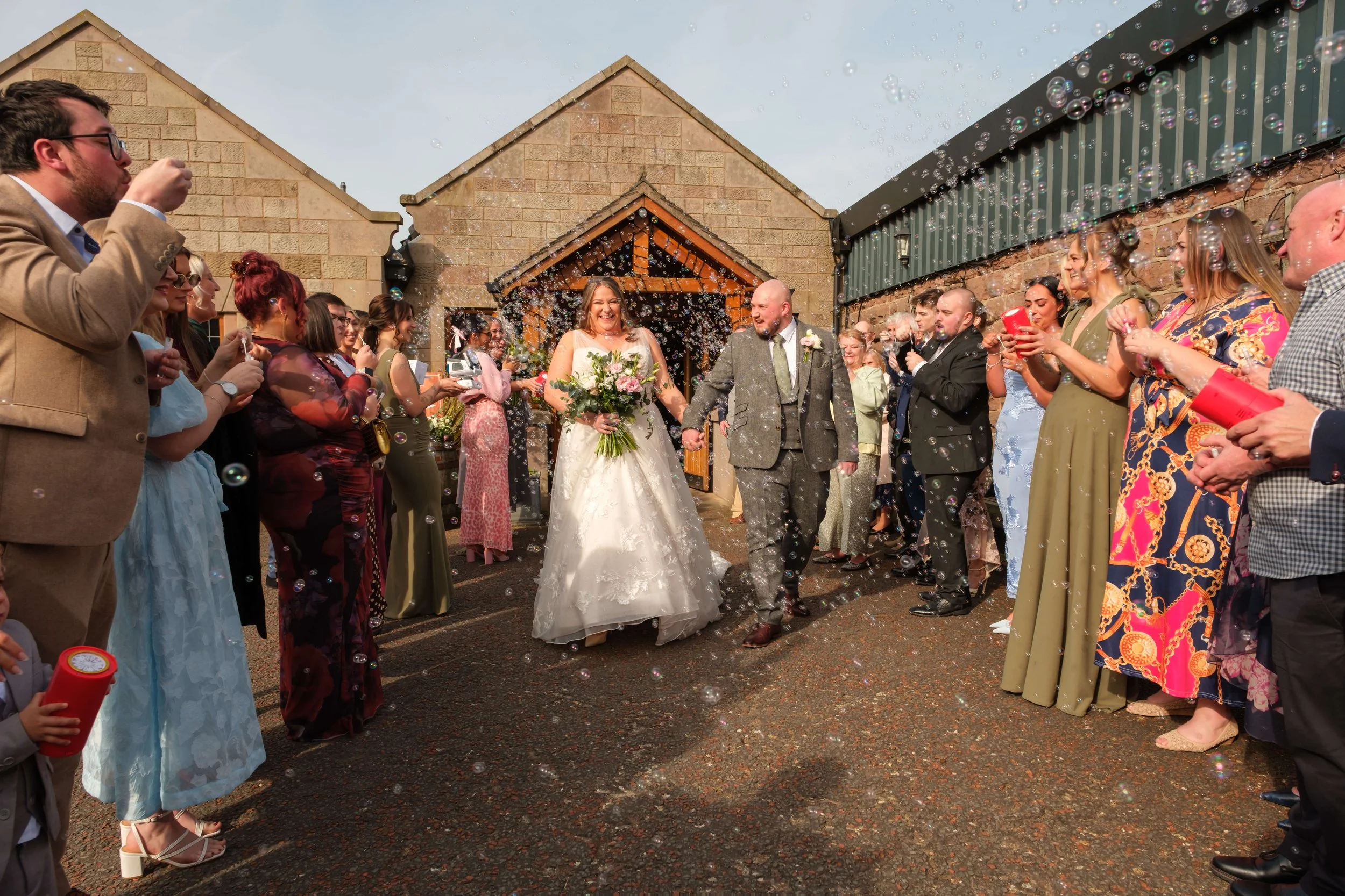 Heaton House Farm Wedding, Bride and Groom surrounded by bubbles instead of conffetti