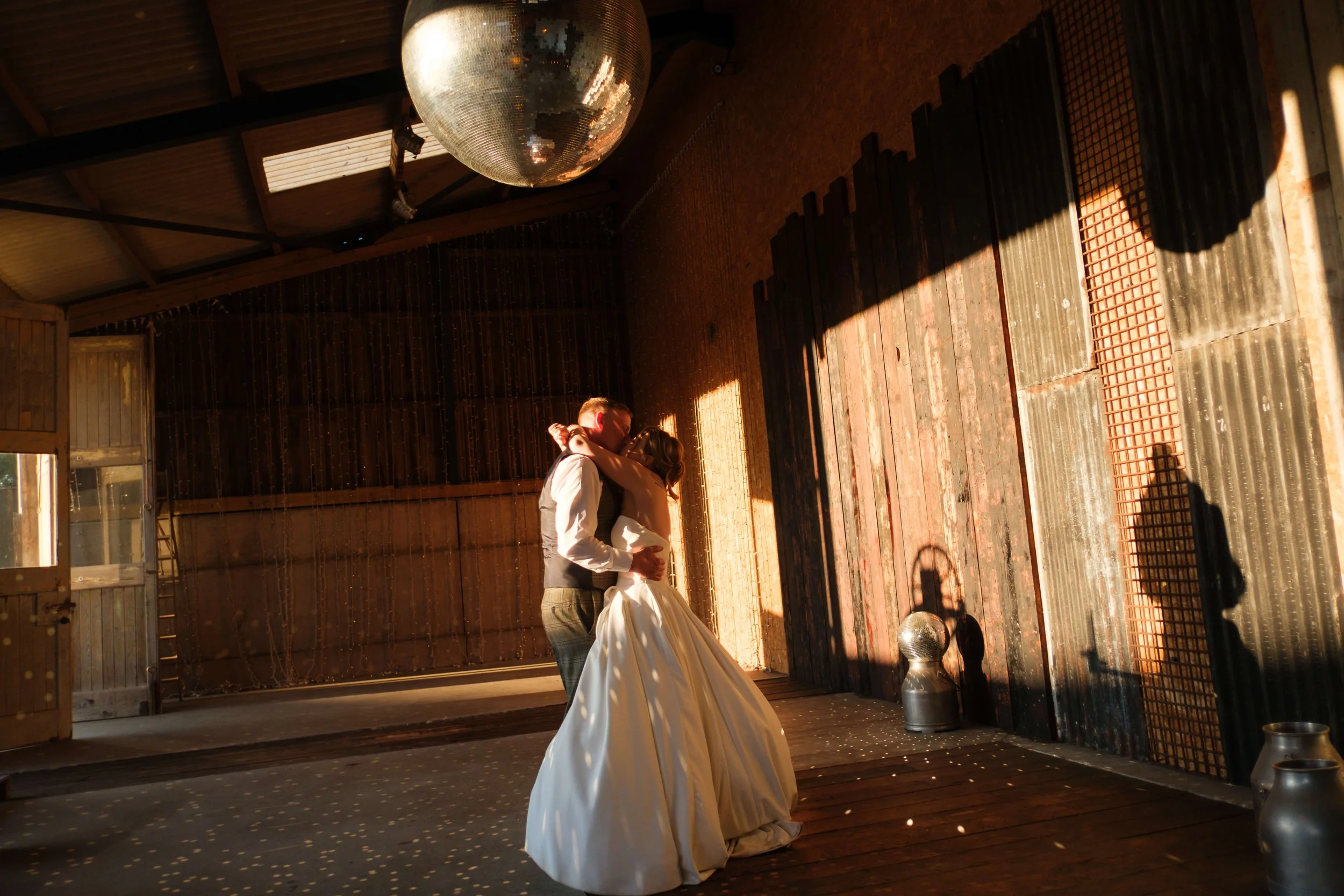 Owen House Wedding Barn wedding, Becky and Liam sharing a kiss in the Shooting Gallery
