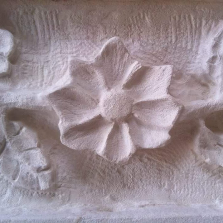 Detail of antiqued Texas limestone fireplace, before final chisel pass.