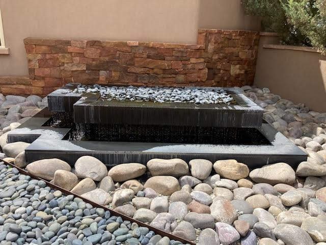 Black granite fountain for private residence in Santa Fe, fabricated and installed in 2012 with hundreds of hand-cut grooves at varying depths to angle the flow of water. (Photo taken during a drought when owner was conserving water.)