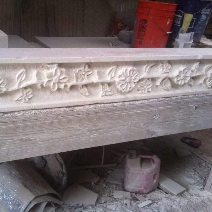 Detail of antiqued Texas limestone fireplace, before final chisel pass.