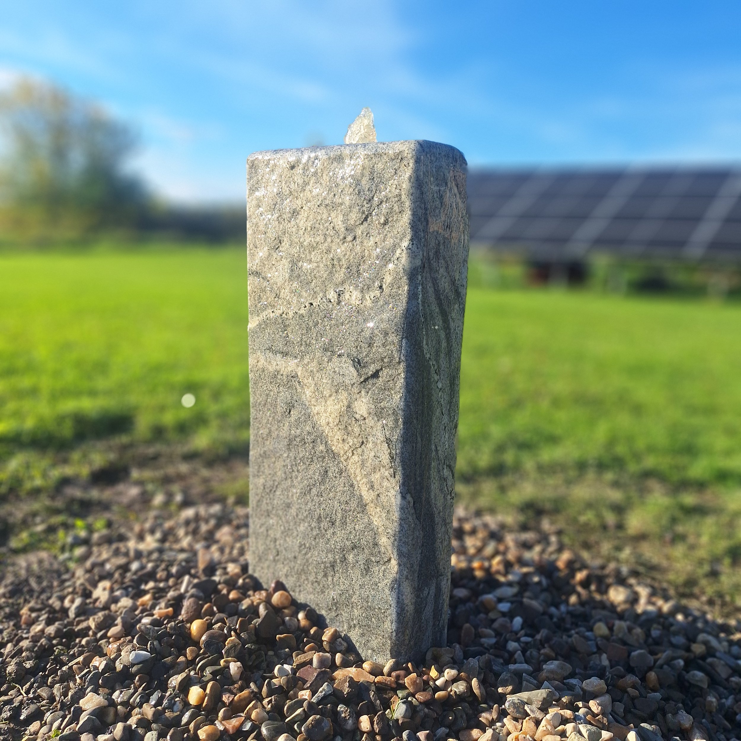 Self-contained fountain carved from reclaimed granite.
