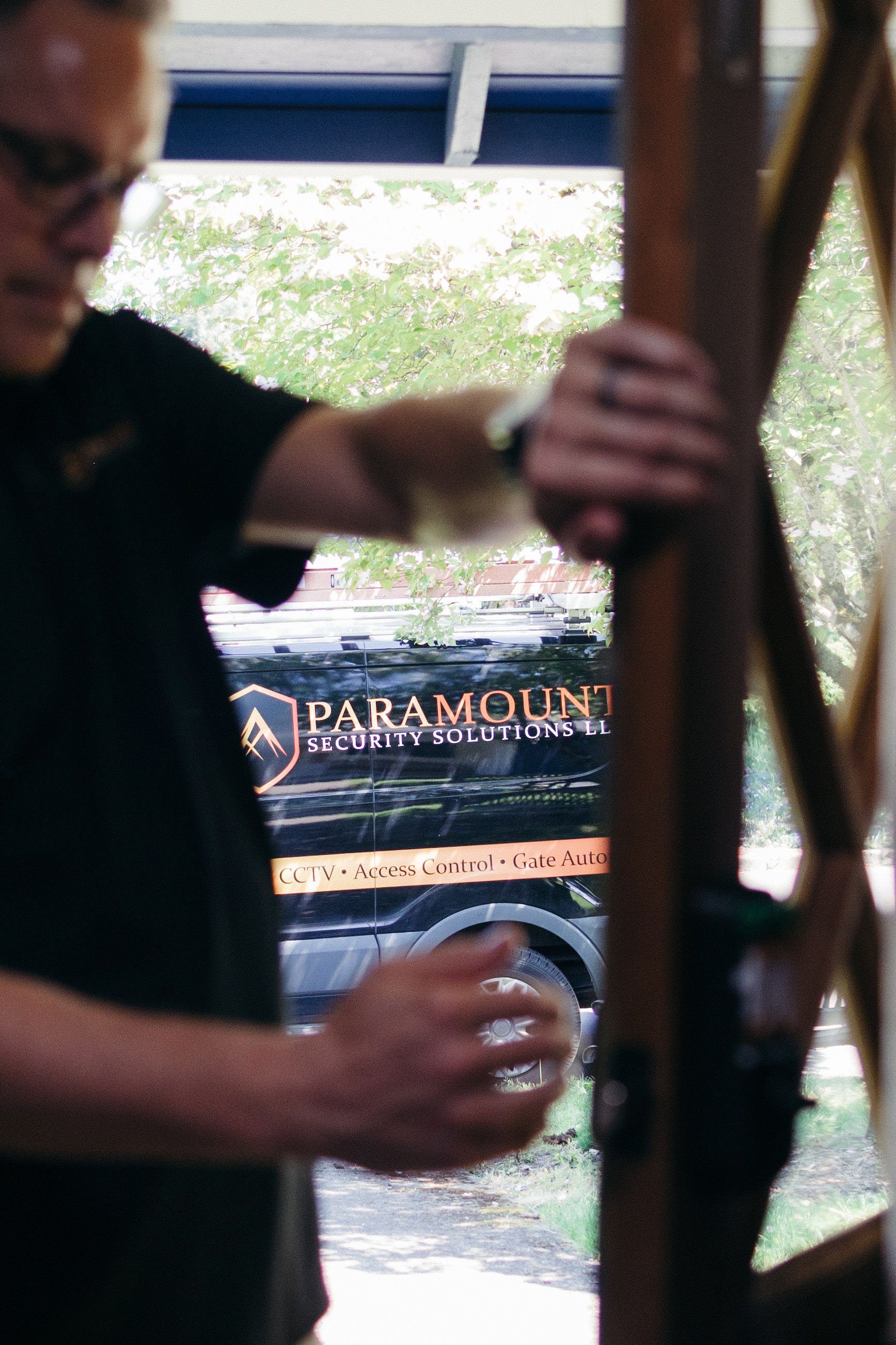 An image of a Paramount Solutions worker examining a door captured by the best brand photographer in Portland
