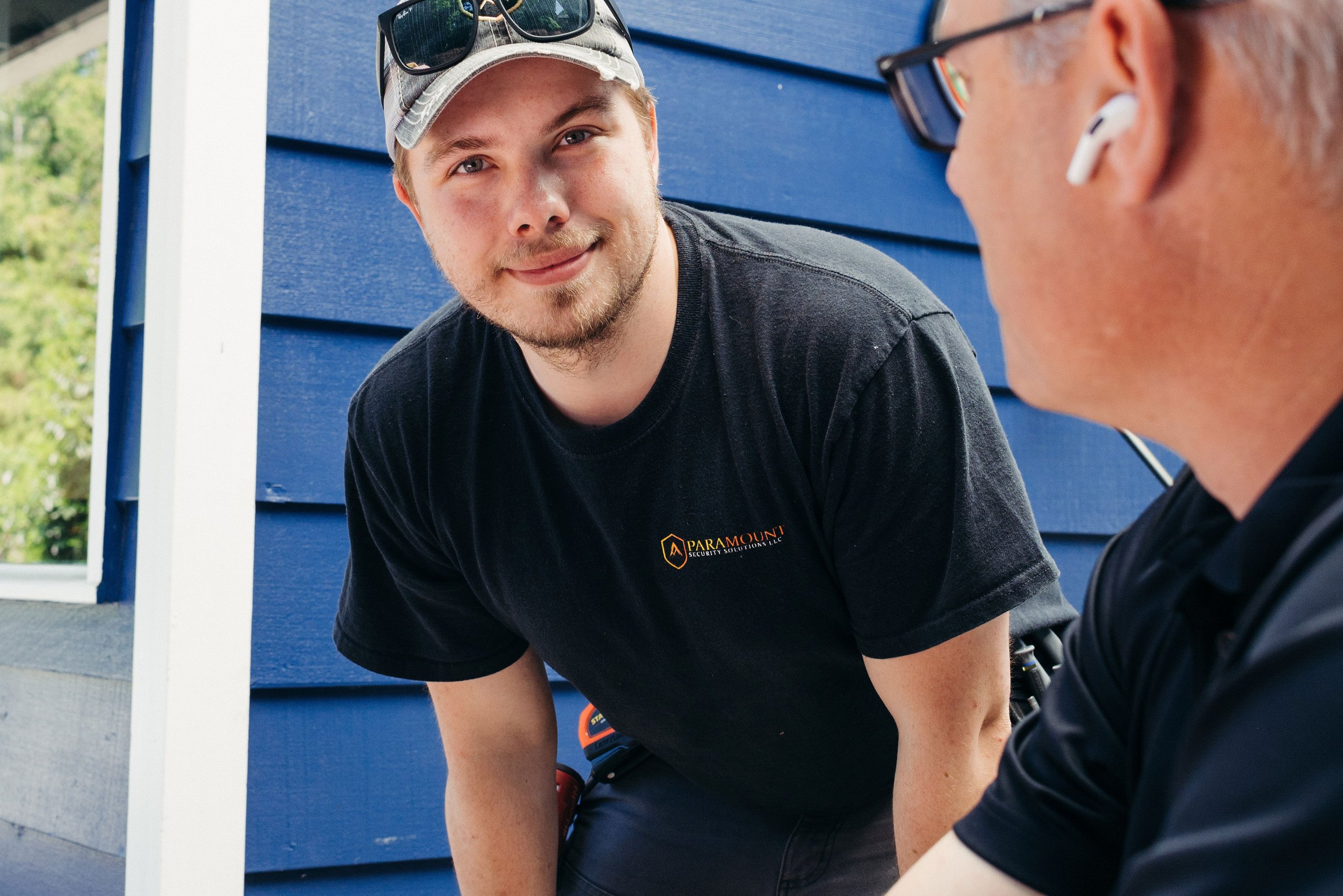 A branding photoshoot for Paramount brand workers captures two workers in the company’s black shirts